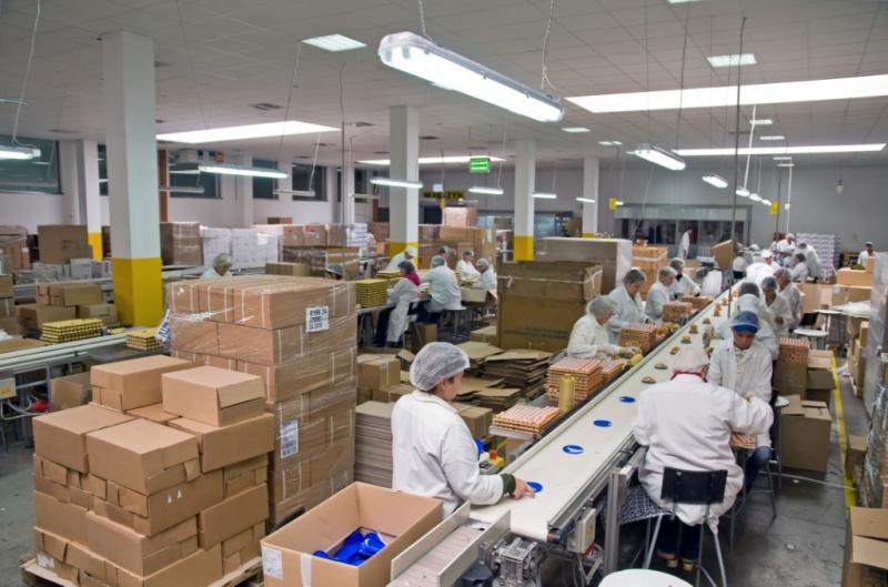 Contract packaging production line with workers, conveyor and packaged products